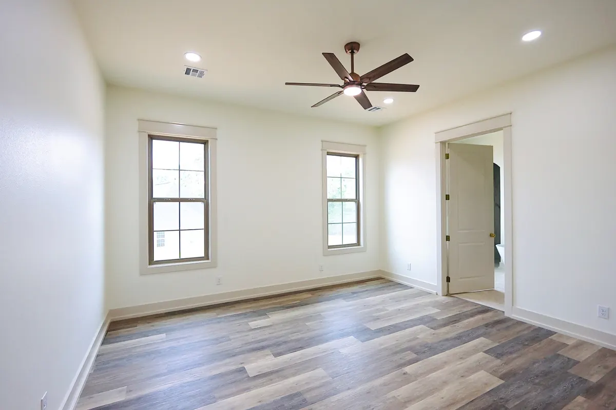 Bedroom with wood-look flooring in a new custom home