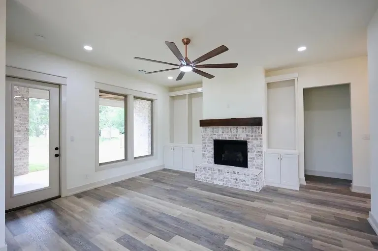 Light-filled living room of a Cutze-built custom home looking out to a covered porch